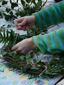 Tying cuttings onto a home made wreath